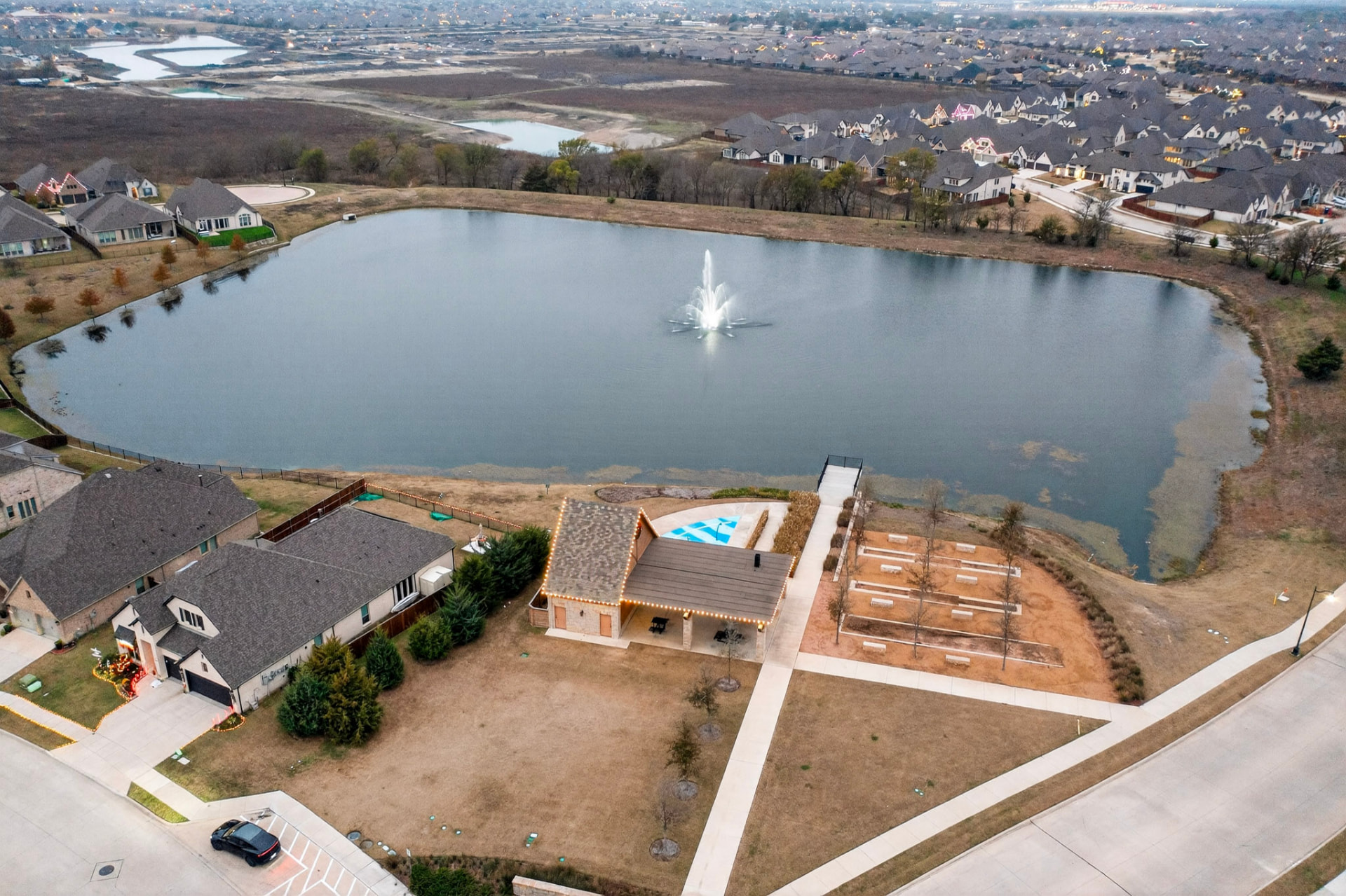 Aerial view of the Devonshire community lake with a fountain.