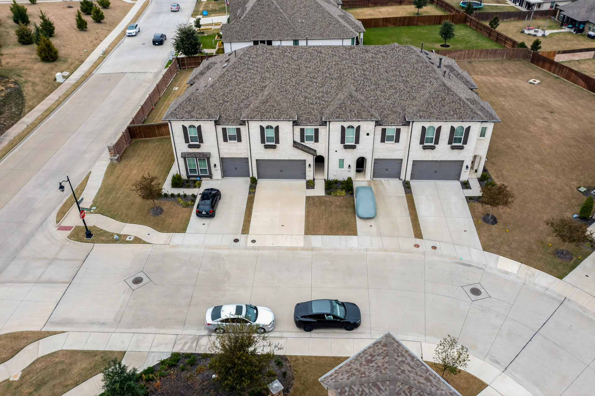 Aerial view of the front of the building and the street with cars.